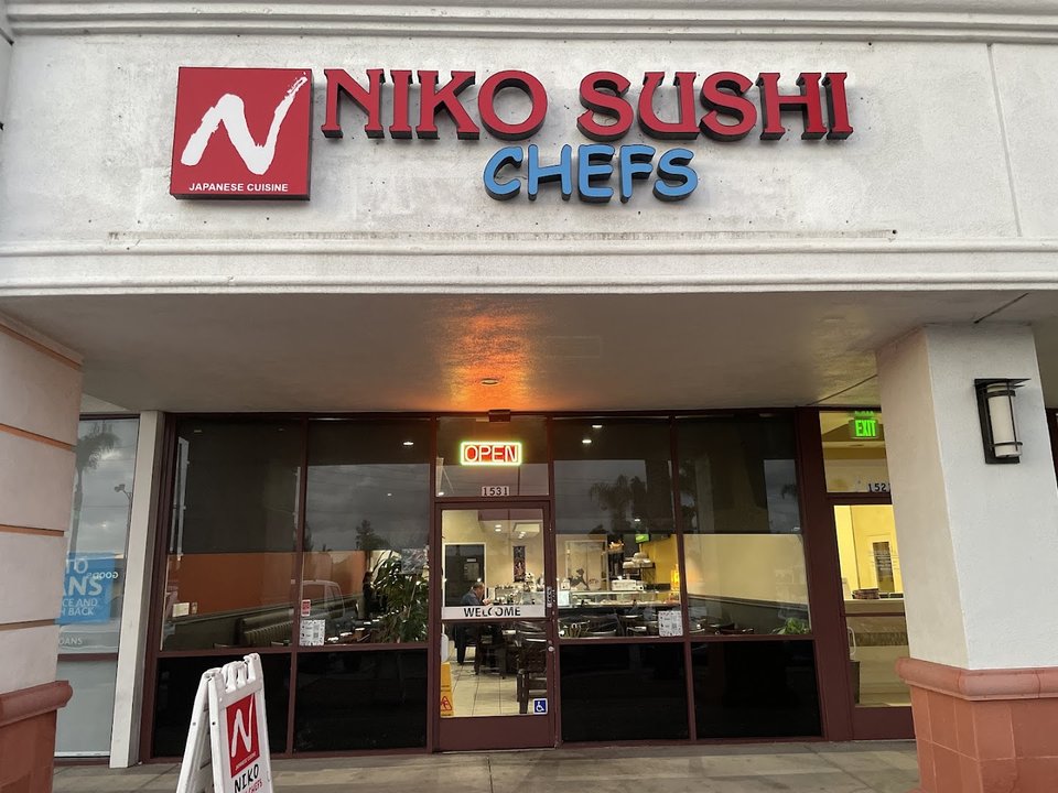 Sushi restaurant exterior in a strip-mall setting.
