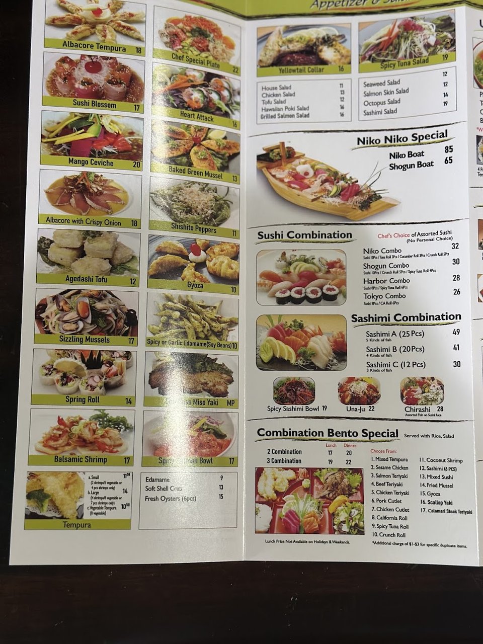 Printed menu beside a plate of sashimi.